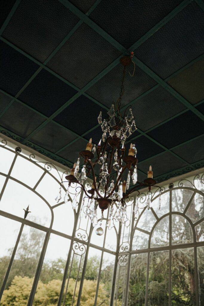 Lustre en cristal suspendu dans l'orangerie du Manoir du Grand Courtoiseau, décoration de mariage